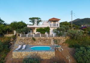 an external view of a house with a swimming pool at Villa Rose in Glossa