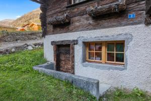 a building with a window on the side of it at Studio chaleureux au coeur d'un chalet alpin in Zinal