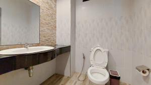 a bathroom with a toilet and a sink at LK Resort in Ban Map Khao Wan