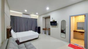 a hotel room with a bed and a television at LK Resort in Ban Map Khao Wan +10 photos