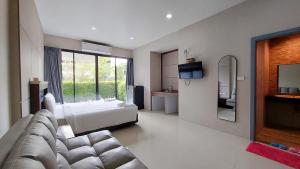 a living room with a couch and a bed at LK Resort in Ban Map Khao Wan