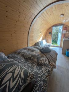 a room with two beds in a circular room at West Point Woods in Barrow in Furness