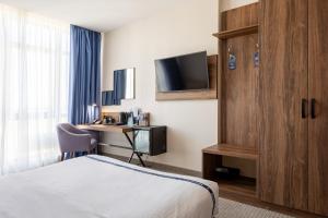 a hotel room with a bed and a desk at Ribas Rooms Odesa in Odesa +34 photos