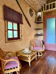 a room with a table and chairs and a door at Treehouses Yao Noi in Ko Yao Noi +24 photos