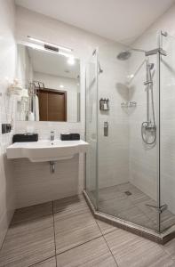 a bathroom with a sink and a shower at Ribas Rooms Odesa in Odesa