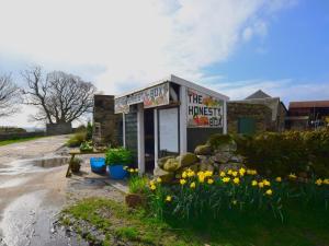 a small building with flowers in front of it at 1 Bed in Isle Of Arran oc-ca344 in Kilmory