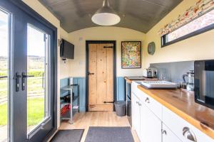 a kitchen with a door leading to a yard at The Carriage in Matlock +2 photos