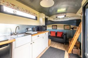 a kitchen and living room with two bunk beds at The Carriage in Matlock
