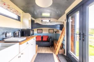 a kitchen and living room in a tiny house at The Carriage in Matlock