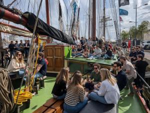a group of people sitting on the deck of a boat at Zeilschip de Alliantie Kampen in Kampen