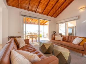 a living room with a couch and a table at Villa Evita Private Pool, Jacuzzi & Sea views in Adeje