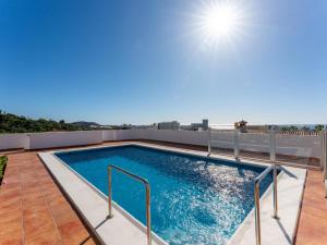 a swimming pool on the roof of a building at Villa Evita Private Pool, Jacuzzi & Sea views in Adeje