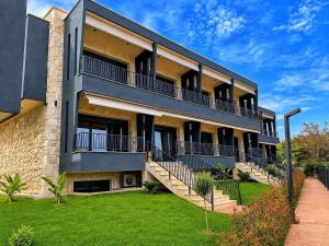 an apartment building with balconies and a lawn at RCR The Stones in Flogita