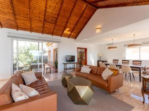 a living room with a couch and a table at Villa Evita Private Pool, Jacuzzi & Sea views in Adeje