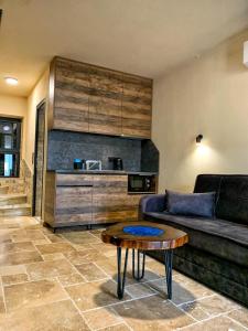 a living room with a couch and a table at RCR The Stones in Flogita