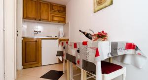 a kitchen with a table and a kitchen with a kitchen gmaxwell gmaxwell gmaxwell at Rooms Radic in Dubrovnik