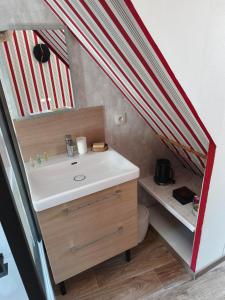 a bathroom with a sink and a toilet in a trailer at Ty Capitaine Chambres d'hôtes Guidel in Guidel
