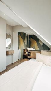 a bedroom with a large bed and a mirror at Hotel Garni Bergblick in Biberach bei Offenburg +40 photos