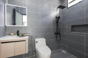 a bathroom with a toilet and a sink and a mirror at Happy House Villa Phu Quoc in Phú Quốc +46 photos