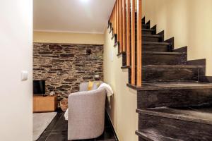 a hallway with a staircase and a stone wall at Férias na Serra # Natureza # Casa da Professora By ALzira in Seia