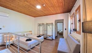 a room with two bunk beds and a wooden ceiling at Villa del Vino in Mikrós Prínos
