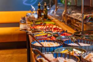 a buffet line with many different dishes of food at Fama Residence Gdańsk Old Town in Gdańsk