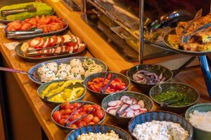 a buffet with many bowls of different types of food at Fama Residence Gdańsk Old Town in Gdańsk +73 photos
