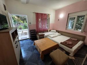 a small room with two beds and a table at Stone Villa in Bečići