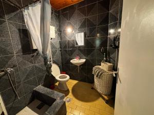 a bathroom with a toilet and a sink at Stone Villa in Bečići