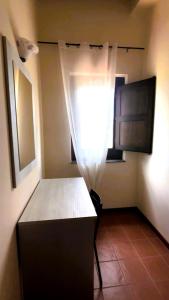 a small room with a window and a table at Tenute Sciara in Randazzo +20 photos