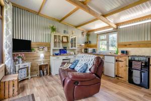 a living room with a leather couch in a kitchen at 1 Bed in Llandovery oc-88603 in Cynghordy