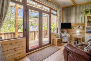 a living room with a sliding glass door at 1 Bed in Llandovery oc-88603 in Cynghordy +26 photos