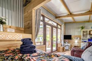 a room with a bed with a stack of towels on it at 1 Bed in Llandovery oc-88603 in Cynghordy