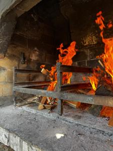 a large brick oven with fire in it at Zidanica Jakec Wine House & Scenic Views in Podlehnik