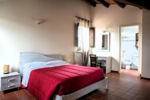 a bedroom with a bed with a red blanket at Tenute Sciara in Randazzo