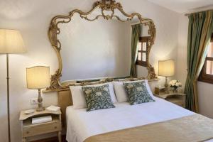 a bedroom with a bed with a large mirror above it at Antico Casale Formica in Bagheria