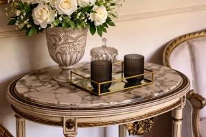 a table with a vase and candles on it at Antico Casale Formica in Bagheria +28 photos