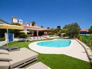 a swimming pool in a yard with a patio and a house at CASA GRAN CANARIA - Gran Canaria Stays in Maspalomas
