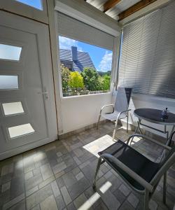 a balcony with a table and chairs and a window at Apartment "North Star" in Dinkelsbühl