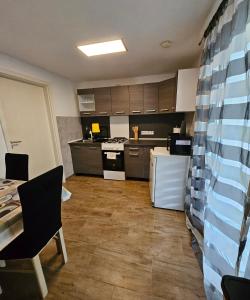a large kitchen with a table and a kitchen with at Apartment "North Star" in Dinkelsbühl