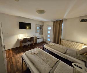 a room with two beds and a desk with a computer at Apartment "North Star" in Dinkelsbühl