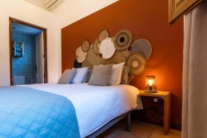 a bedroom with a bed with a stuffed monkey on the wall at Casa Sabor de la Vida in Abarán +78 photos