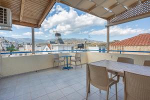 a patio with a table and chairs on a balcony at Nikos House in Ierapetra