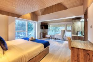 a bedroom with a large bed and a desk at Kason Grand View Manali in Manāli