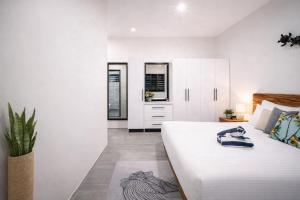 a bedroom with a large bed and white cabinets at Solana Properties in Nadi +23 photos
