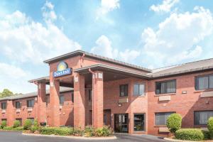 a red brick building with a hotel sign on it at Days Inn By Wyndham Phenix City Near Fort Moore in Phenix City