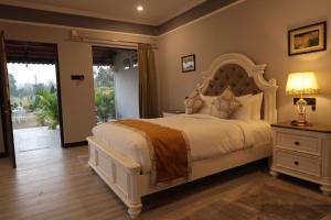 a bedroom with a large white bed and a window at Tuli Orchid - A Boutique Eco Resort in Rāmtek +41 photos