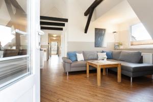 a living room with a couch and a table at Vadersdorf 31 Im Backhaus in Vadersdorf