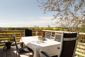 a table and chairs on a deck with a view at Vadersdorf 31 Im Backhaus in Vadersdorf +30 photos