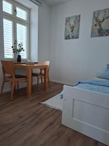 a bedroom with a dining room table and a bed at Apartmá 575 in Strakonice